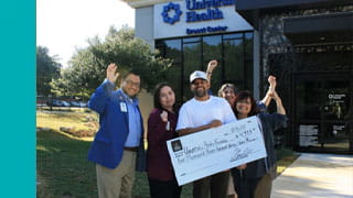 Group standing outside of University Health Clinic
