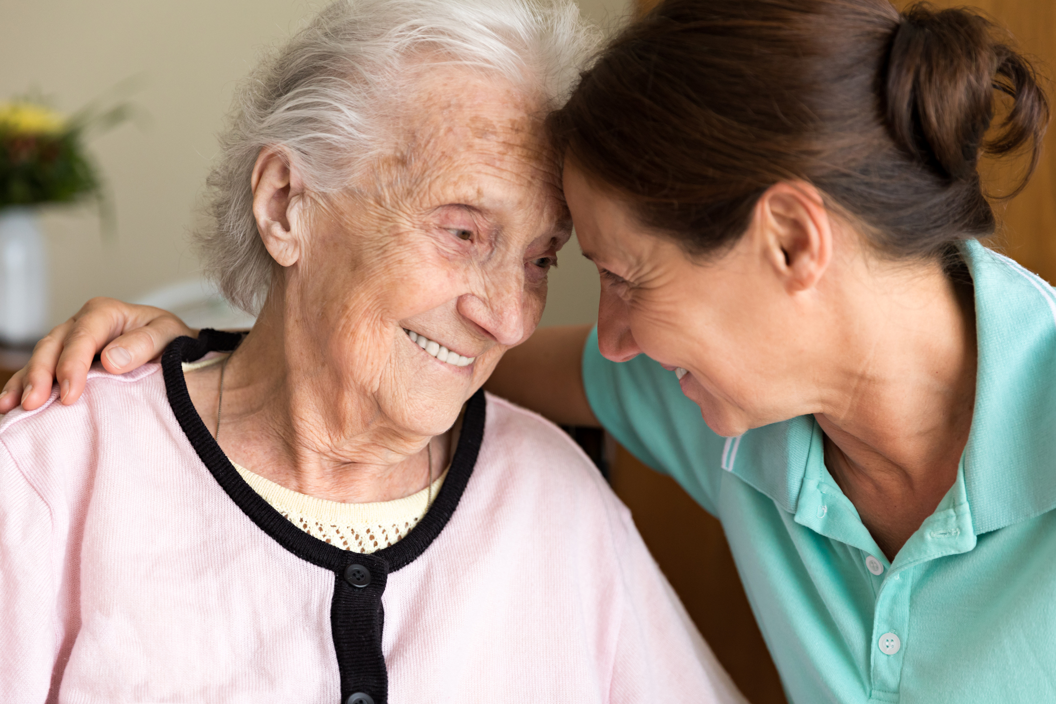 Elderly woman and caregiver