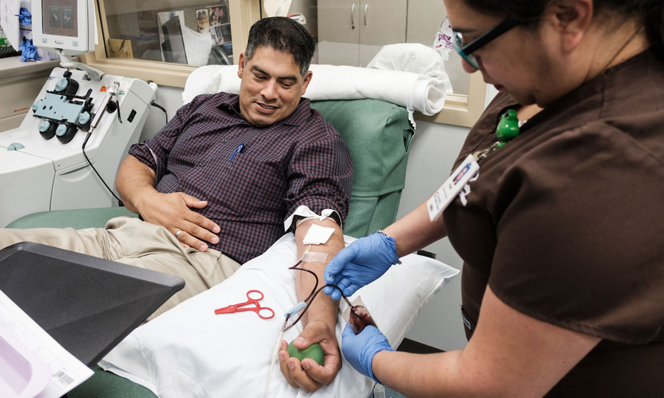 a man donating his blood at the lab