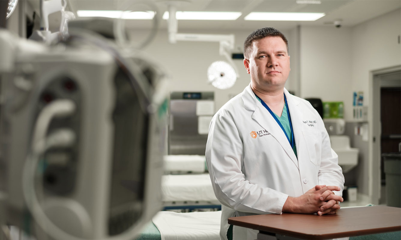 Dr. Muir poses in an operating room