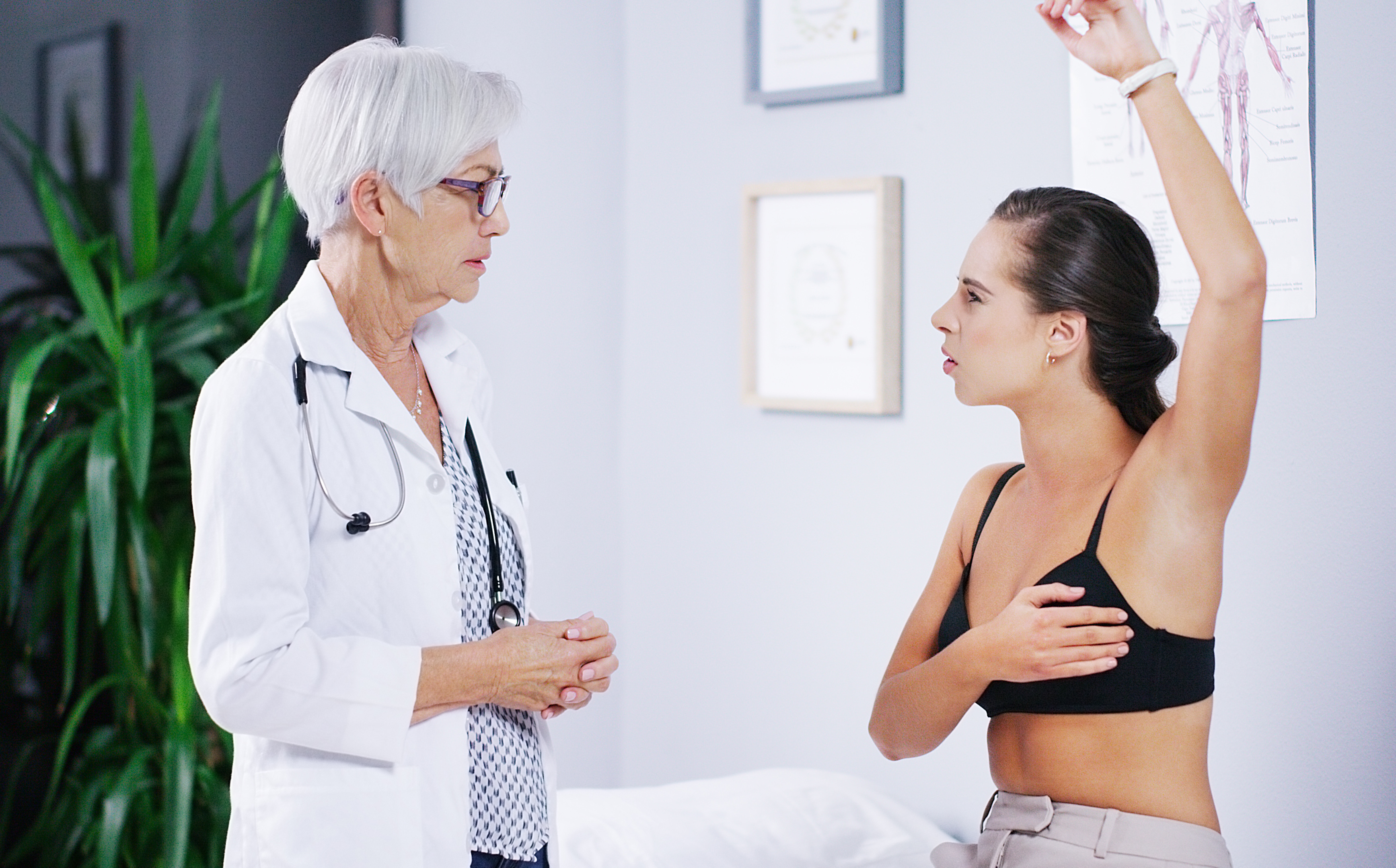 female patient talks to her female doctor about changes in her breast