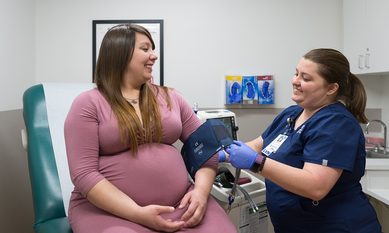 pregnant woman gets her blood pressure tested