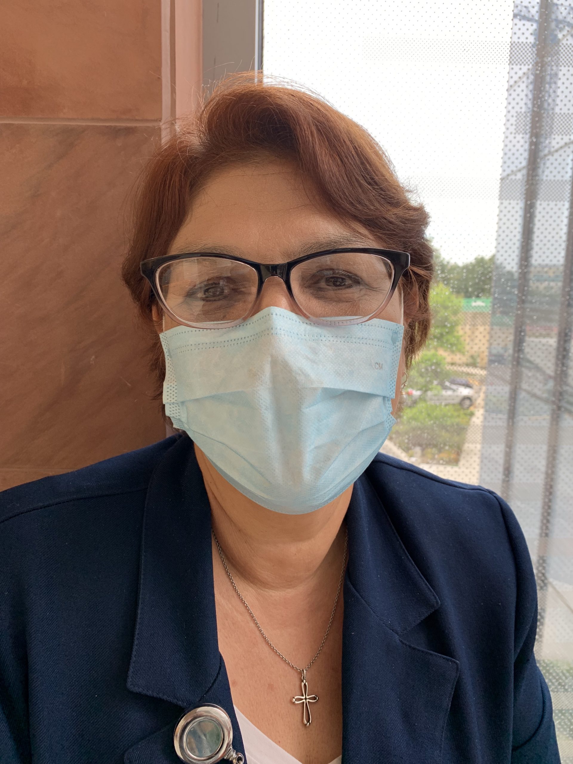 a female healthcare worker wears a mask