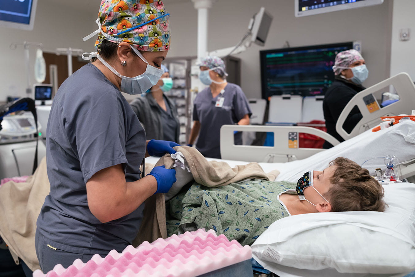 The transplant surgical team prepares 14-year-old Hayes Atkins for surgery in the operating room at University Hospital. 