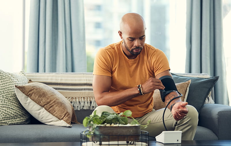 A man measures his blood pressure at home