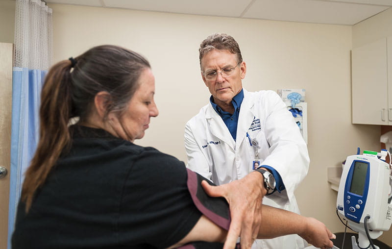 University Health family nurse practitioner, Ernest Prince checking patient’s blood pressure.