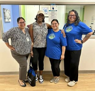 Denise standing with team members