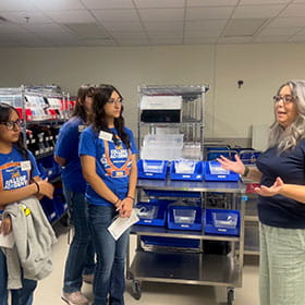 Students taking a tour at a pharmacy.