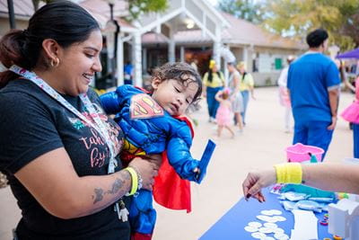 PREMIEre program baby with mother at Fall Fest