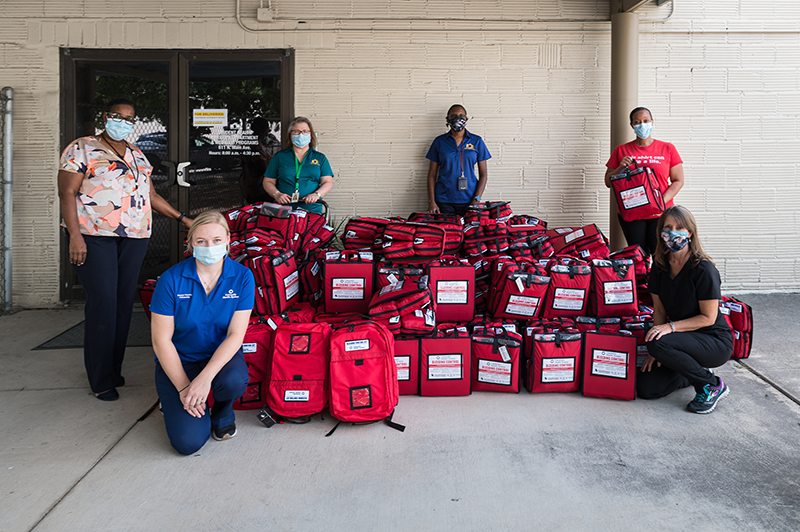Trauma team posing next to Stop the Bleed kits