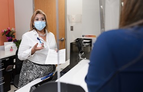CareLink employee wearing a mask, helping a customer