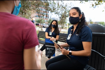 CareLink employee wearing a mask, helping a customer