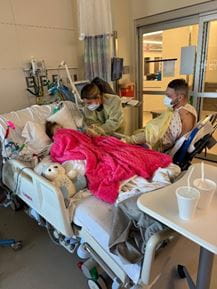 Hospital room with the family and child inside