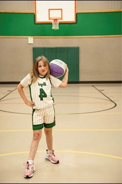 Liver transplant recipient posing with basketball