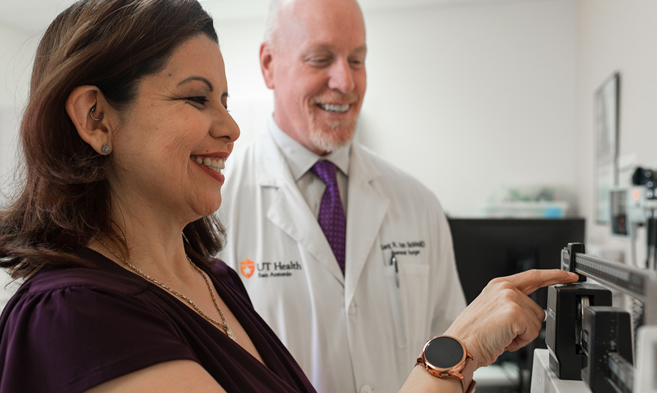 bariatric patient gets weighed as her doctor looks on