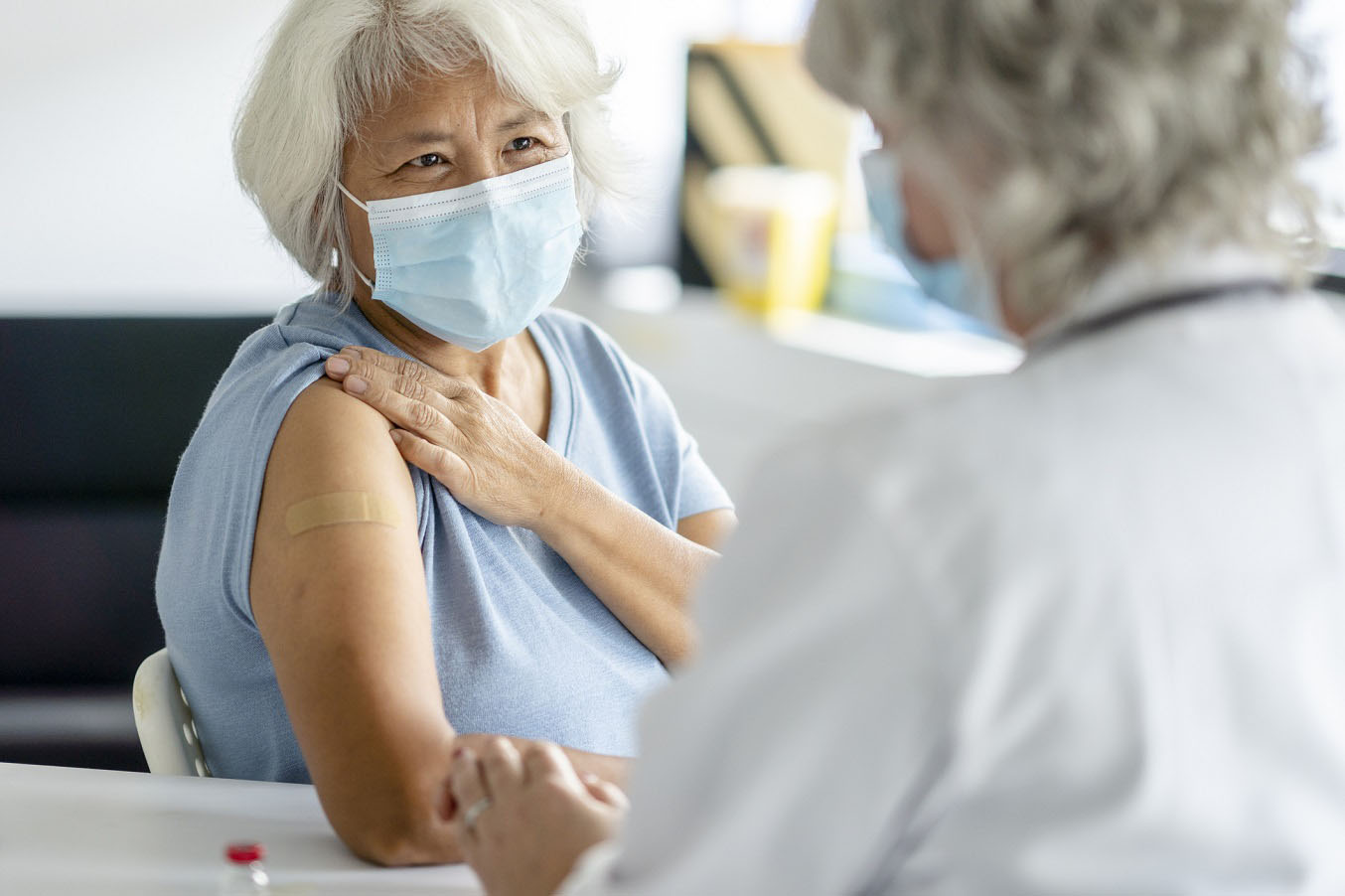University Health pharmacy team member delivering a free flu vaccination during a flu shot drive event at Dub Farris Athletic Complex.