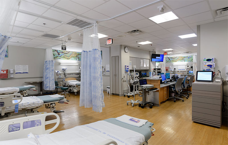Patient beds with privacy curtains inside San Antonio’s only 24/7 center for ob/gyn emergencies.