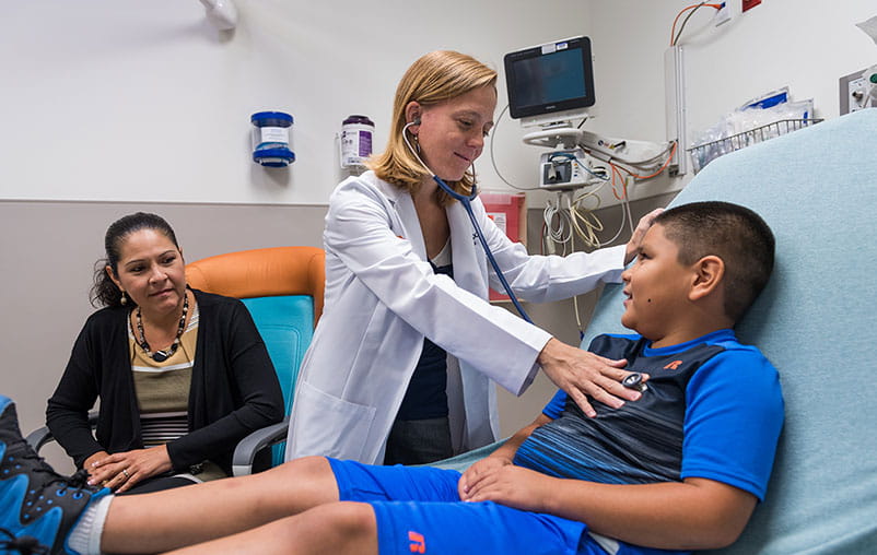 University Health provider listening to pediatric patients heart. 