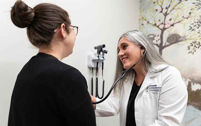 University Health physician, Sveta Singh, is checking on a female patient at University Health Huebner Commons. 