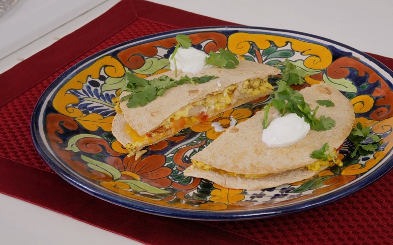 Healthy breakfast quesadilla on a colorful plate.